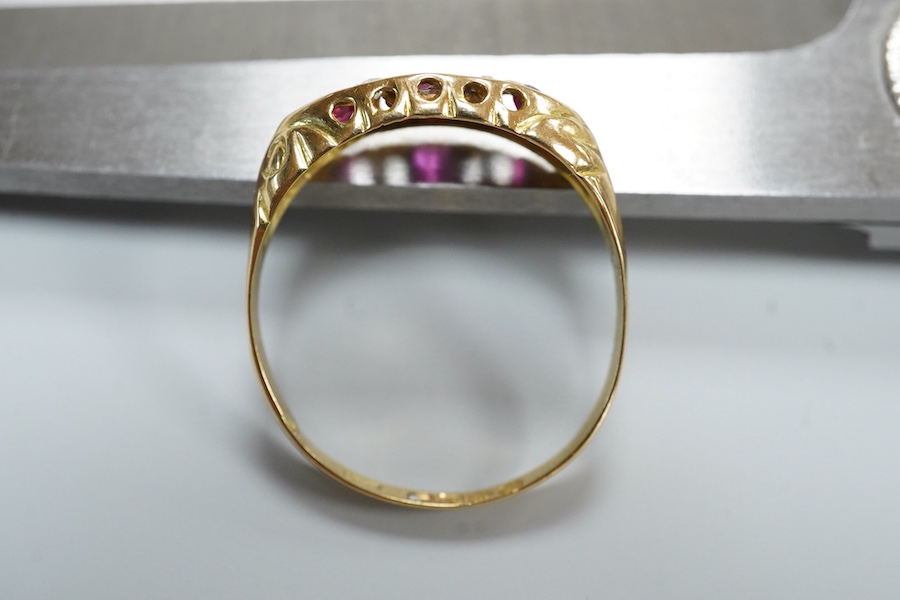 A ruby and diamond ring, circa 1916, set with three circular-cut rubies, spaced by pairs of circular-cut diamonds, mounted in 18ct gold, size R1/2, British hallmarks, gross weight approximately 2 grams, one ruby syntheti